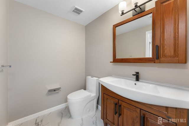 bathroom featuring vanity and toilet