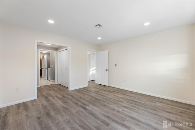 unfurnished bedroom featuring a closet and light hardwood / wood-style flooring