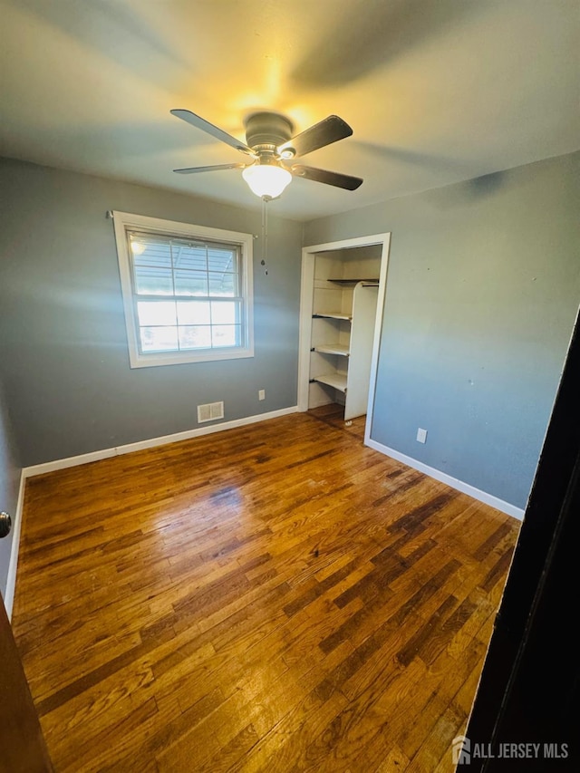 19 Spruce St, Port Reading, NJ 07064 - unfurnished bedroom featuring wood finished floors, baseboards, and ceiling fan