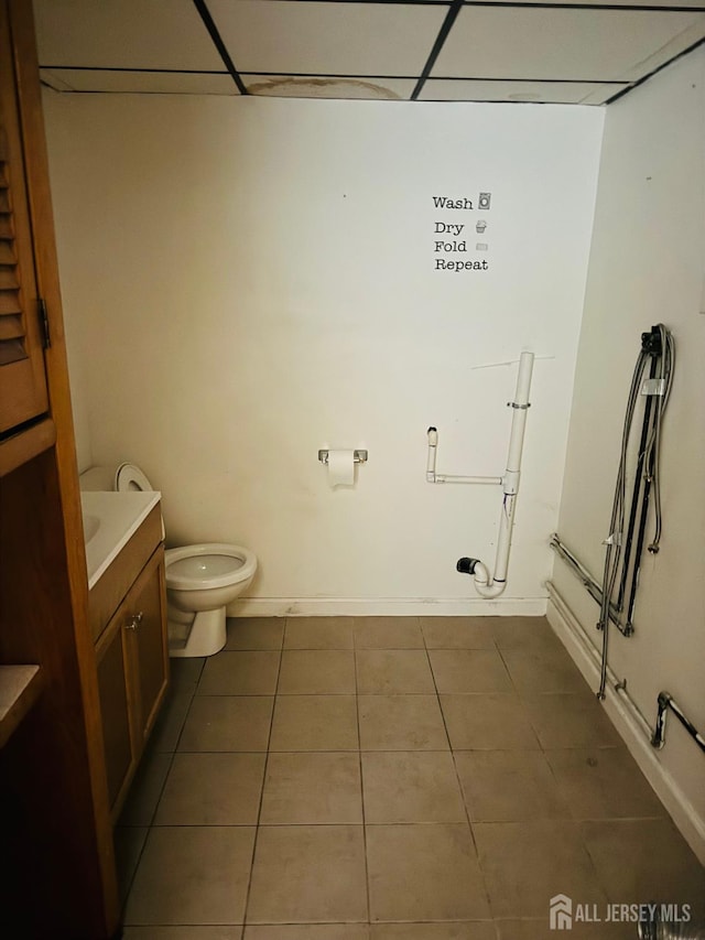 19 Spruce St, Port Reading, NJ 07064 - bathroom with tile patterned flooring, toilet, vanity, baseboards, and a drop ceiling