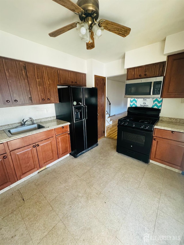 19 Spruce St, Port Reading, NJ 07064 - kitchen featuring black appliances, a sink, a ceiling fan, and light countertops