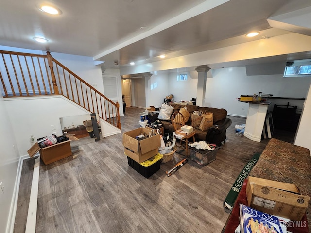 living room featuring stairs, recessed lighting, wood finished floors, and baseboards