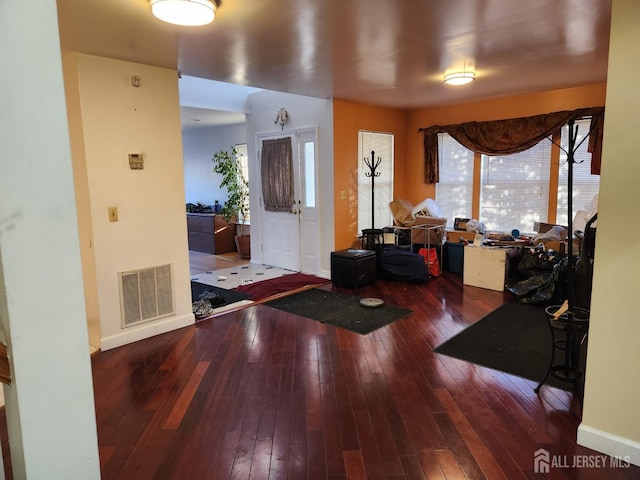 entryway with visible vents, baseboards, and hardwood / wood-style floors