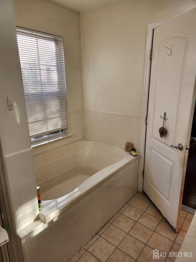 bathroom featuring tile patterned floors and a garden tub