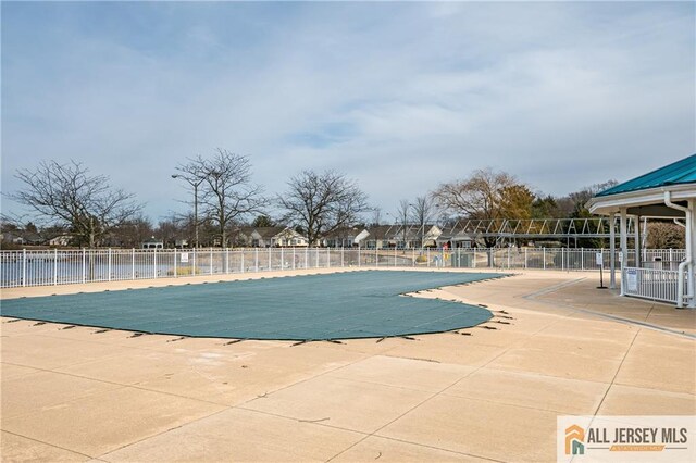 pool featuring fence and a patio