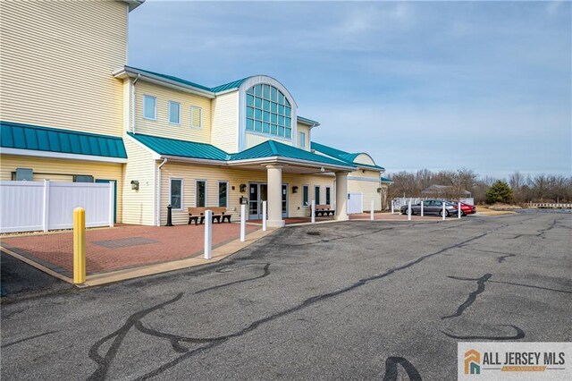 exterior space with fence and metal roof