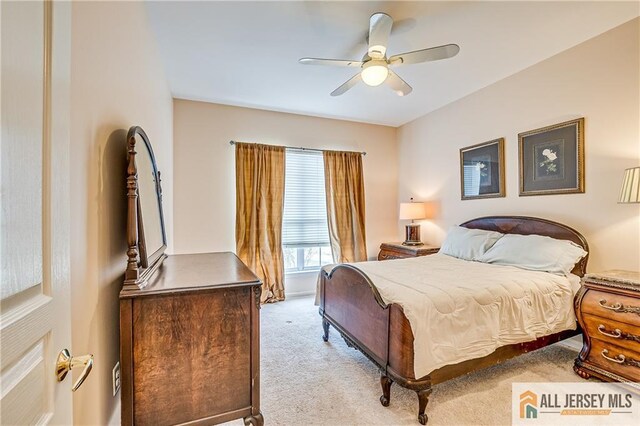 bedroom featuring a ceiling fan and light colored carpet