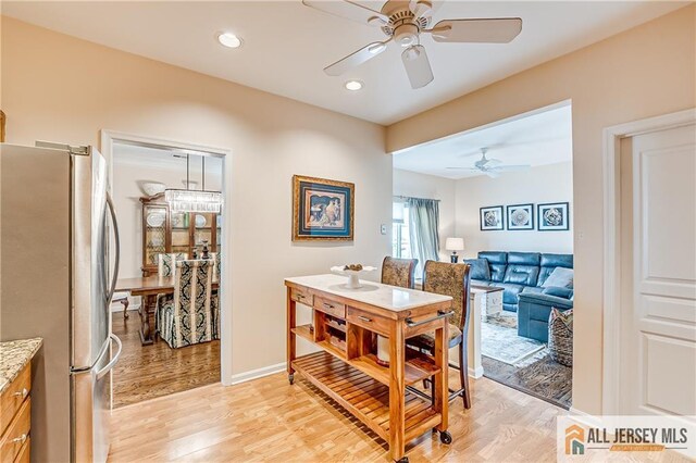 dining area featuring a ceiling fan, recessed lighting, baseboards, and light wood finished floors