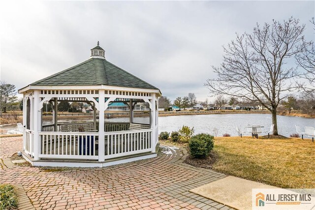 view of patio with a water view and a gazebo