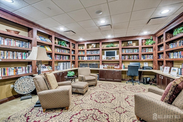 carpeted home office featuring built in desk, bookshelves, and recessed lighting