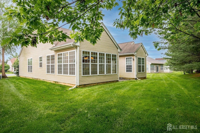 back of property featuring a yard