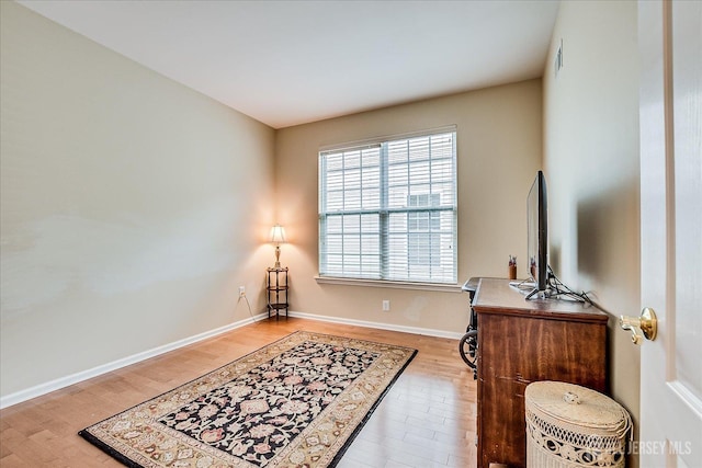 office space with wood finished floors and baseboards