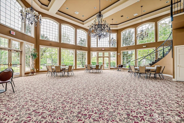 sunroom featuring plenty of natural light, french doors, and a chandelier