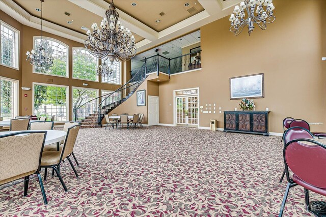 carpeted dining area featuring a chandelier, a high ceiling, baseboards, stairway, and beamed ceiling