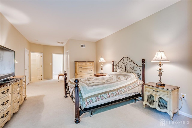 bedroom featuring light colored carpet and baseboards