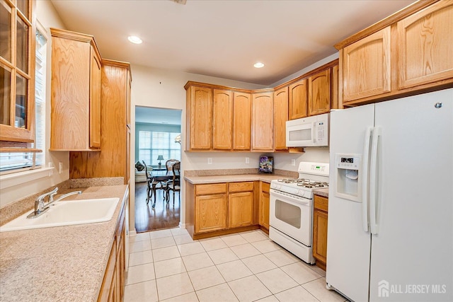 kitchen featuring white appliances, a sink, plenty of natural light, light tile patterned floors, and recessed lighting