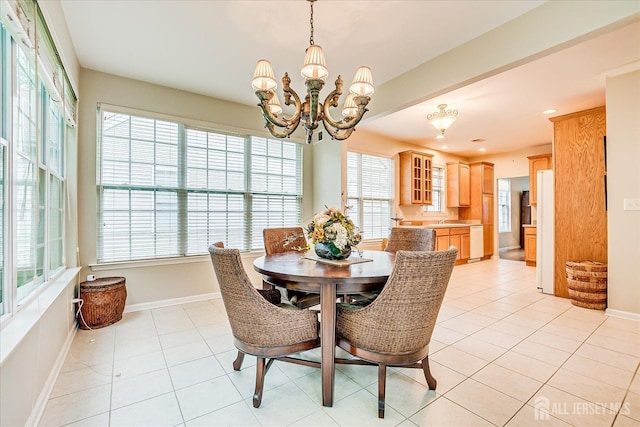 dining area featuring healthy amount of natural light, a chandelier, baseboards, and recessed lighting