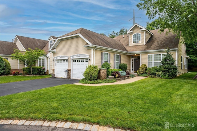 view of front facade featuring asphalt driveway, an attached garage, a front lawn, and a shingled roof