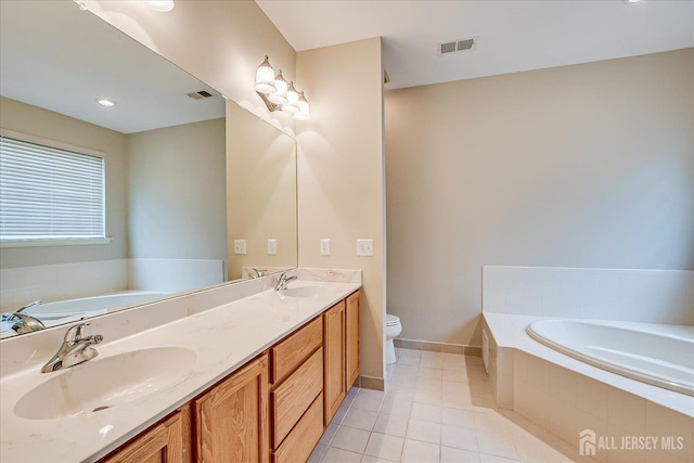 full bath featuring tile patterned floors, a bath, double vanity, baseboards, and toilet