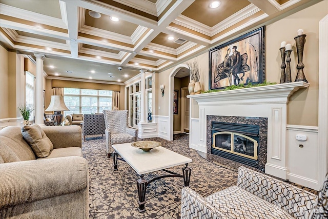 living area with ornamental molding, coffered ceiling, beam ceiling, arched walkways, and a fireplace