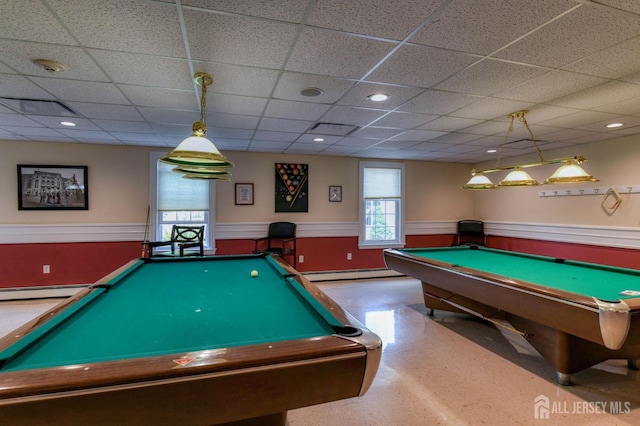 recreation room with pool table, a drop ceiling, a wainscoted wall, and a baseboard radiator