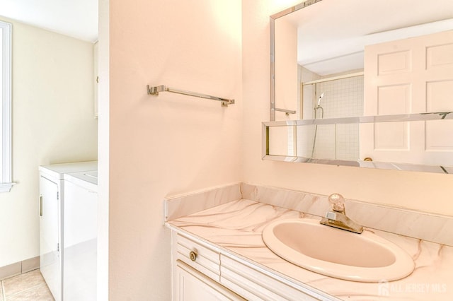 full bathroom with vanity, independent washer and dryer, and walk in shower