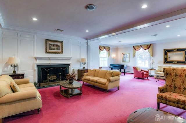 living room featuring crown molding, carpet, visible vents, and a fireplace