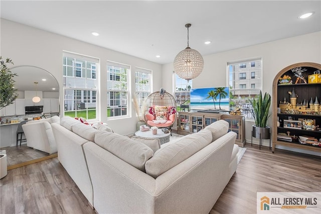 702 Station Rd, Dunellen, NJ 08812 - living area with light wood-style flooring, a chandelier, and recessed lighting