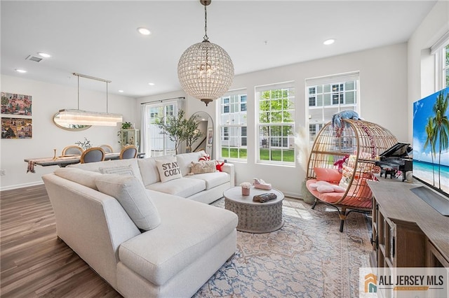 702 Station Rd, Dunellen, NJ 08812 - living room featuring healthy amount of natural light, a chandelier, wood finished floors, recessed lighting, and baseboards