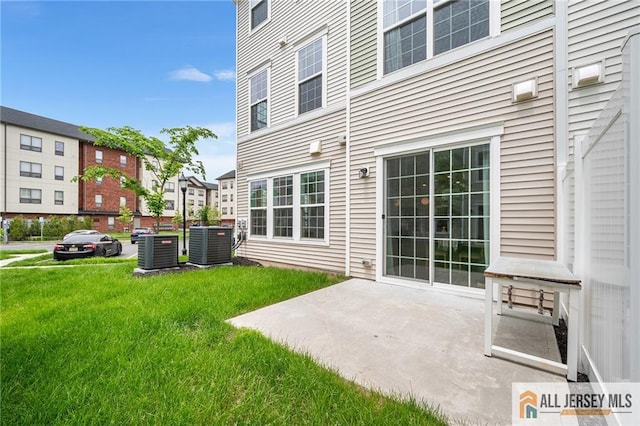 702 Station Rd, Dunellen, NJ 08812 - back of house with cooling unit, a yard, and a patio area