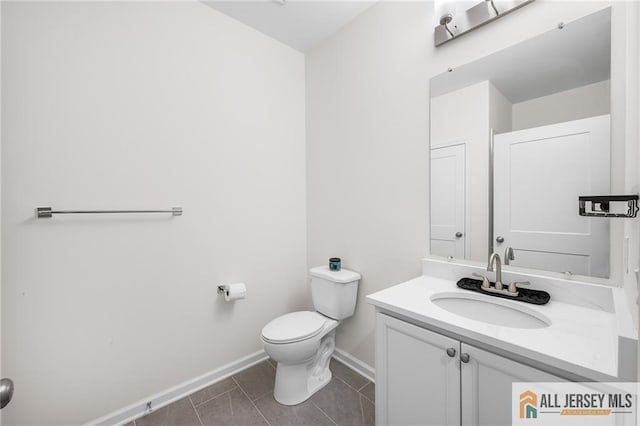 702 Station Rd, Dunellen, NJ 08812 - bathroom featuring baseboards, vanity, toilet, and tile patterned flooring