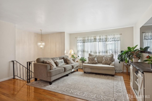 living room featuring a chandelier and wood-type flooring