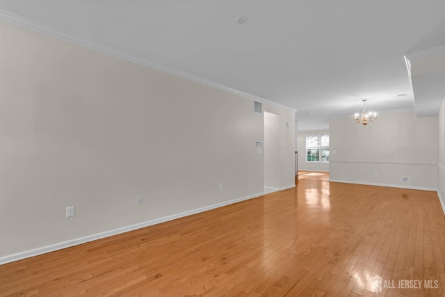 97 Osprey Dr, Old Bridge, NJ 08857 - spare room featuring ornamental molding, a chandelier, and light wood finished floors