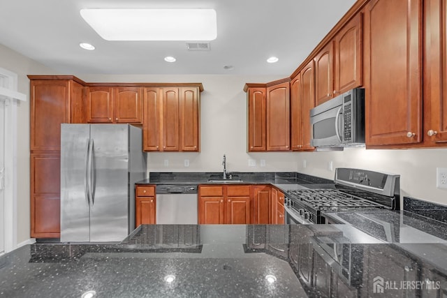 97 Osprey Dr, Old Bridge, NJ 08857 - kitchen featuring appliances with stainless steel finishes, dark stone counters, recessed lighting, and brown cabinetry