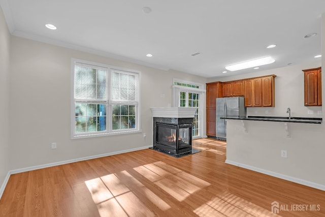 97 Osprey Dr, Old Bridge, NJ 08857 - kitchen with freestanding refrigerator, dark countertops, light wood-style flooring, brown cabinetry, and recessed lighting