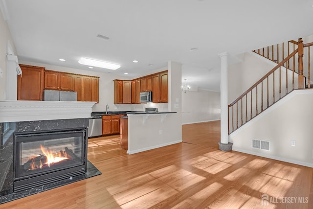 97 Osprey Dr, Old Bridge, NJ 08857 - kitchen with stainless steel appliances, light wood-style flooring, recessed lighting, a fireplace, and a peninsula