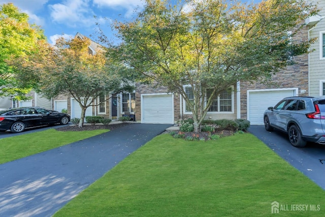97 Osprey Dr, Old Bridge, NJ 08857 - view of property hidden behind natural elements with asphalt driveway, a front yard, and stone siding