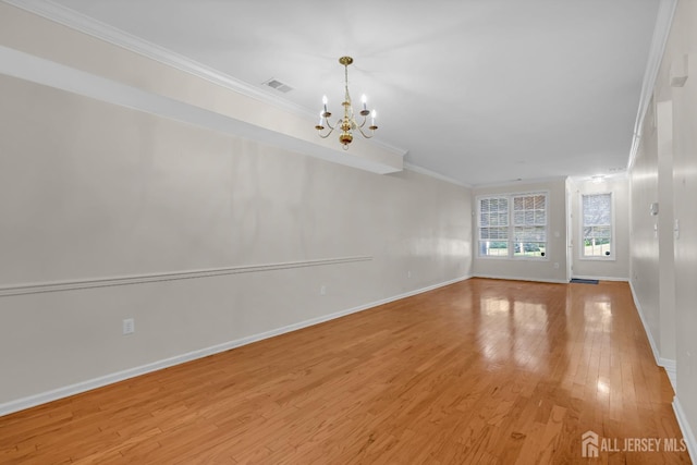 97 Osprey Dr, Old Bridge, NJ 08857 - unfurnished living room featuring light wood-style floors, crown molding, and a chandelier