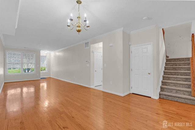 97 Osprey Dr, Old Bridge, NJ 08857 - unfurnished living room with stairs, crown molding, light wood-type flooring, and a chandelier