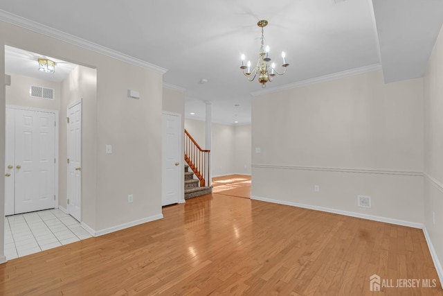 97 Osprey Dr, Old Bridge, NJ 08857 - empty room featuring stairs, light wood-type flooring, a chandelier, and crown molding