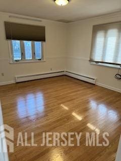 empty room with hardwood / wood-style flooring