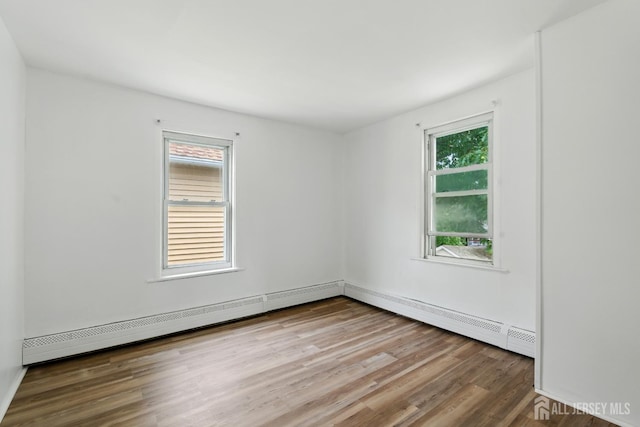 309 1st St, Keyport, NJ 07735 - spare room featuring wood finished floors and baseboard heating