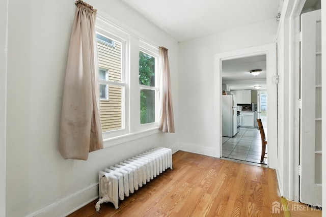 309 1st St, Keyport, NJ 07735 - hallway with radiator heating unit and light wood-type flooring