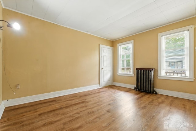 309 1st St, Keyport, NJ 07735 - spare room featuring ornamental molding, radiator, and wood finished floors