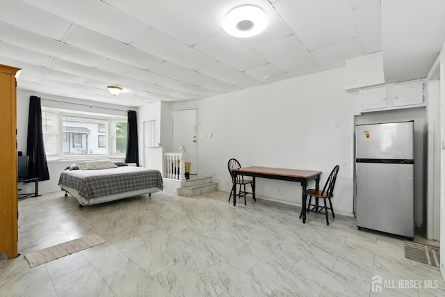 309 1st St, Keyport, NJ 07735 - bedroom with freestanding refrigerator and light marble finish floors