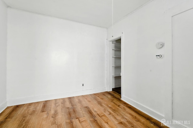 309 1st St, Keyport, NJ 07735 - unfurnished bedroom with light wood finished floors, crown molding, and a closet