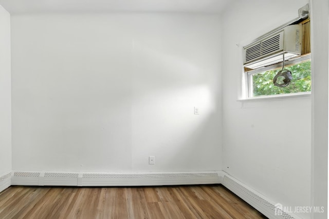 309 1st St, Keyport, NJ 07735 - spare room featuring a baseboard heating unit and wood finished floors