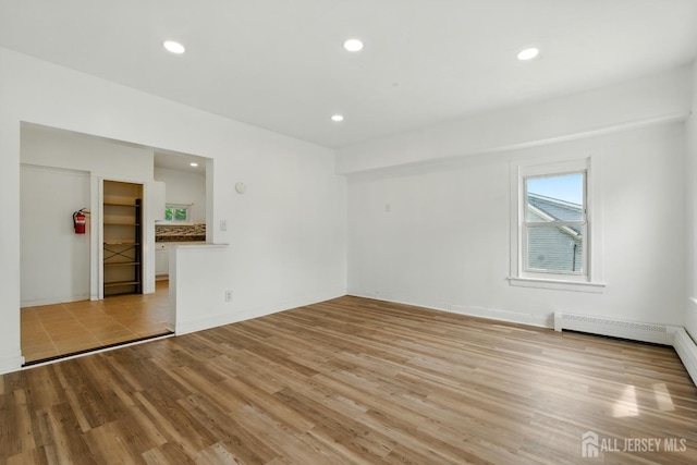 309 1st St, Keyport, NJ 07735 - unfurnished room with light wood finished floors, recessed lighting, and baseboard heating