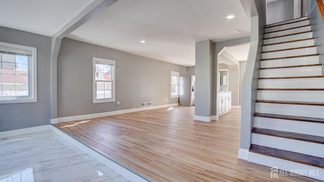 stairs with baseboards, recessed lighting, and marble finish flooring