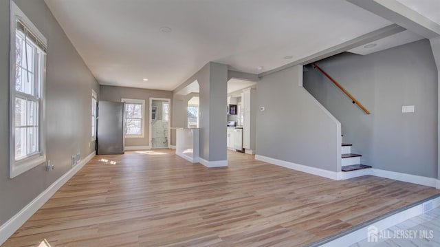 entrance foyer featuring light wood finished floors, stairway, baseboards, and recessed lighting